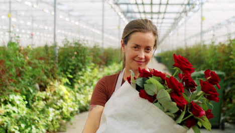 Joyous-Female-Florist-with-Roses-in-Flower-Greenhouse